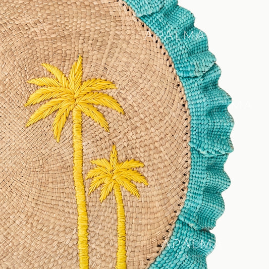 Woven mat with embroidered palm trees and turquoise border